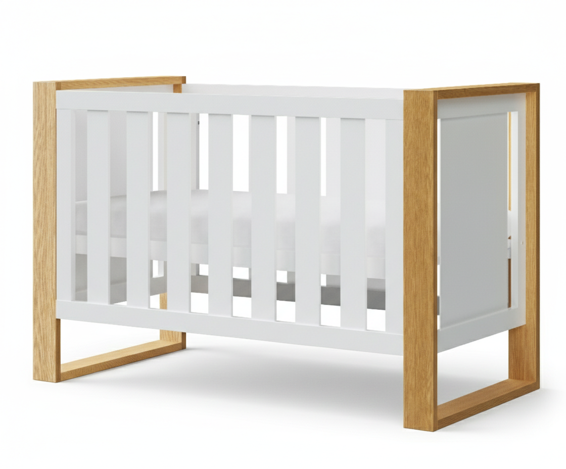 Smiling baby girl on blanket in front of white baby crib, wooden blocks, Babyhood GCC