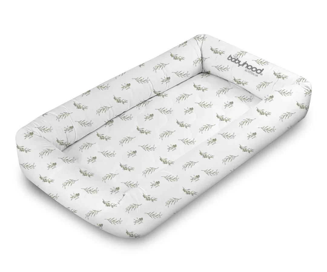 Babyhood Cosy Crib in olive leaf print, soft rectangular baby nest, white background
