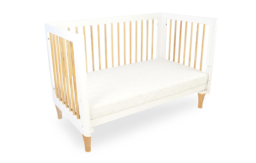 Modern white and natural wood baby cot toddler bed on plain background, Babyhood GCC