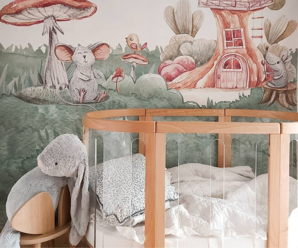 Wooden baby crib in whimsical nursery with forest animal mural, Babyhood GCC decor