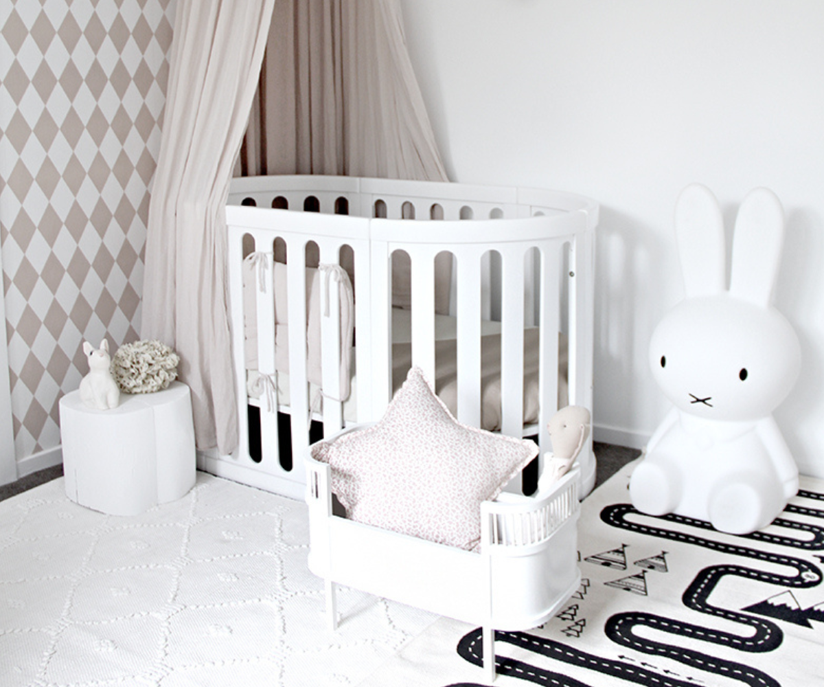 Modern baby nursery with white crib, large bunny decor, and soft neutral accents from Babyhood GCC