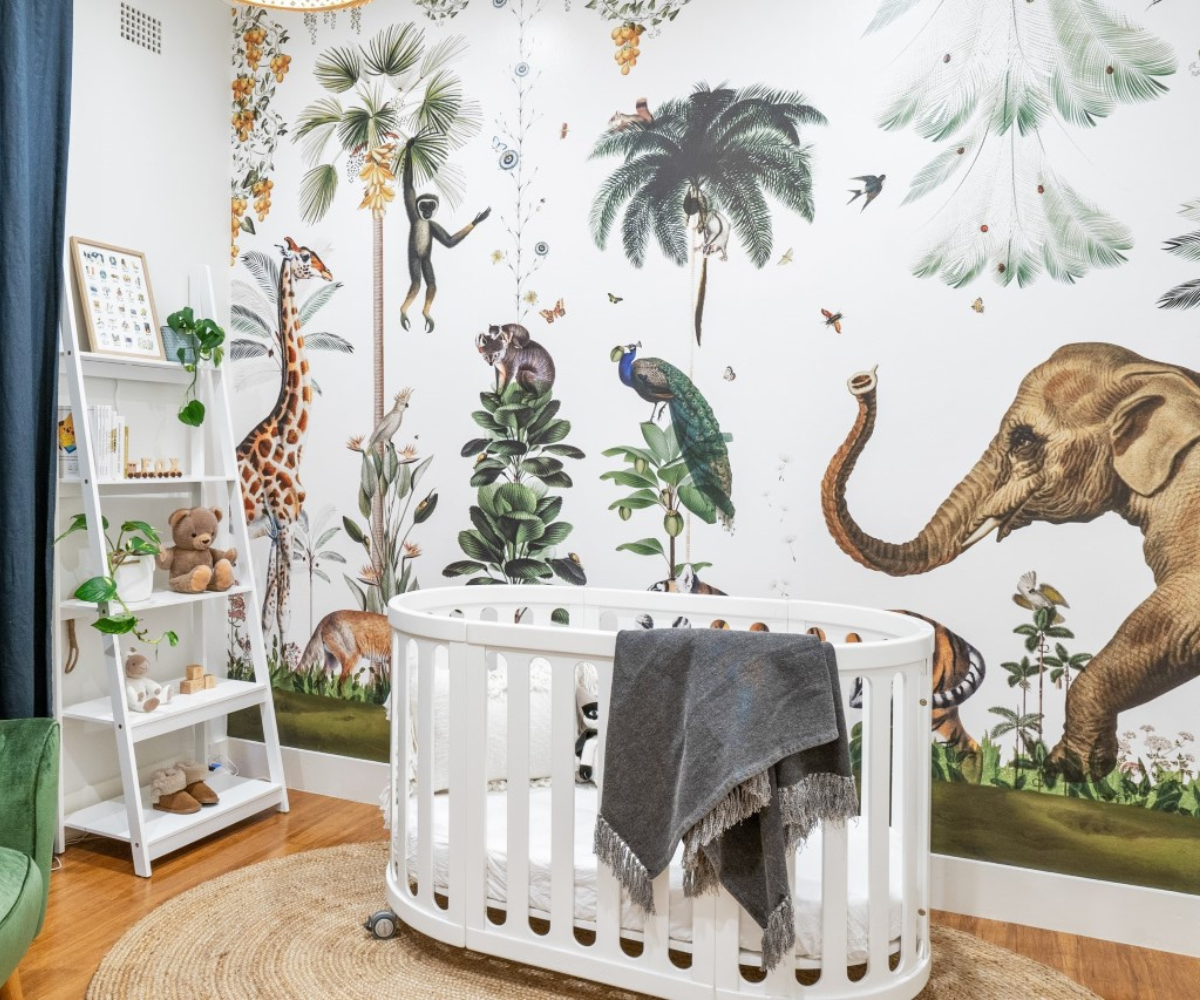 Baby nursery with white crib, jungle animal wall mural, and plush toys, Babyhood GCC