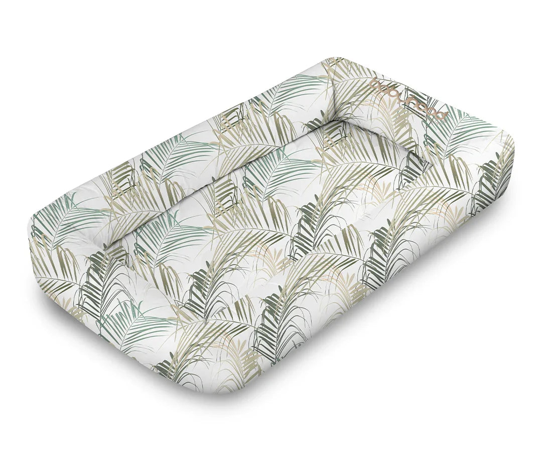 Babyhood Cosy Crib with green palm leaf print, soft baby lounger on white background