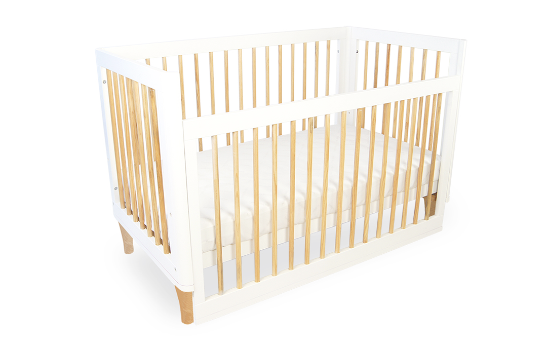 Modern white wooden baby cot with natural wood slats from Babyhood GCC.
